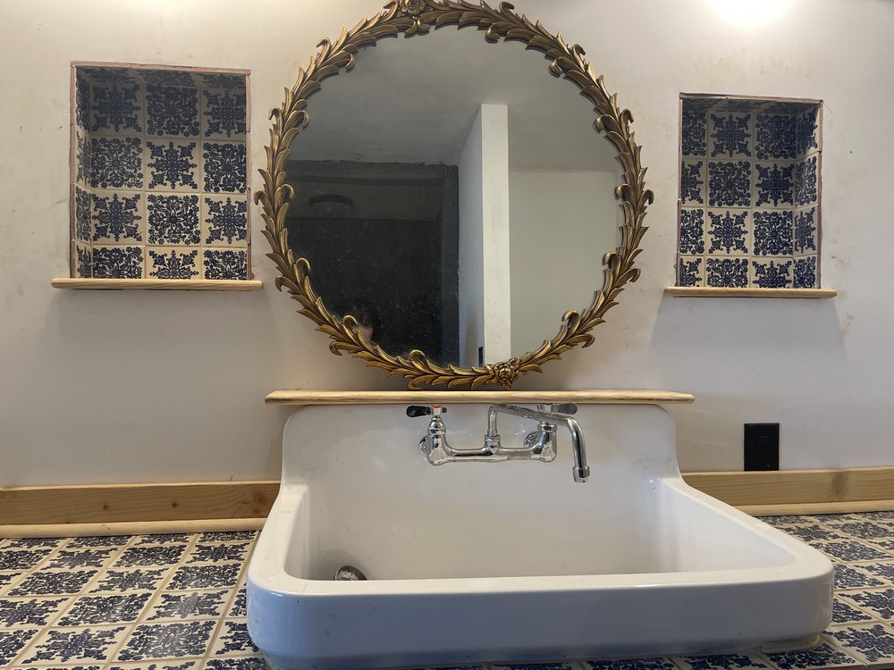 Bathroom with vintage sink and ornate mirror