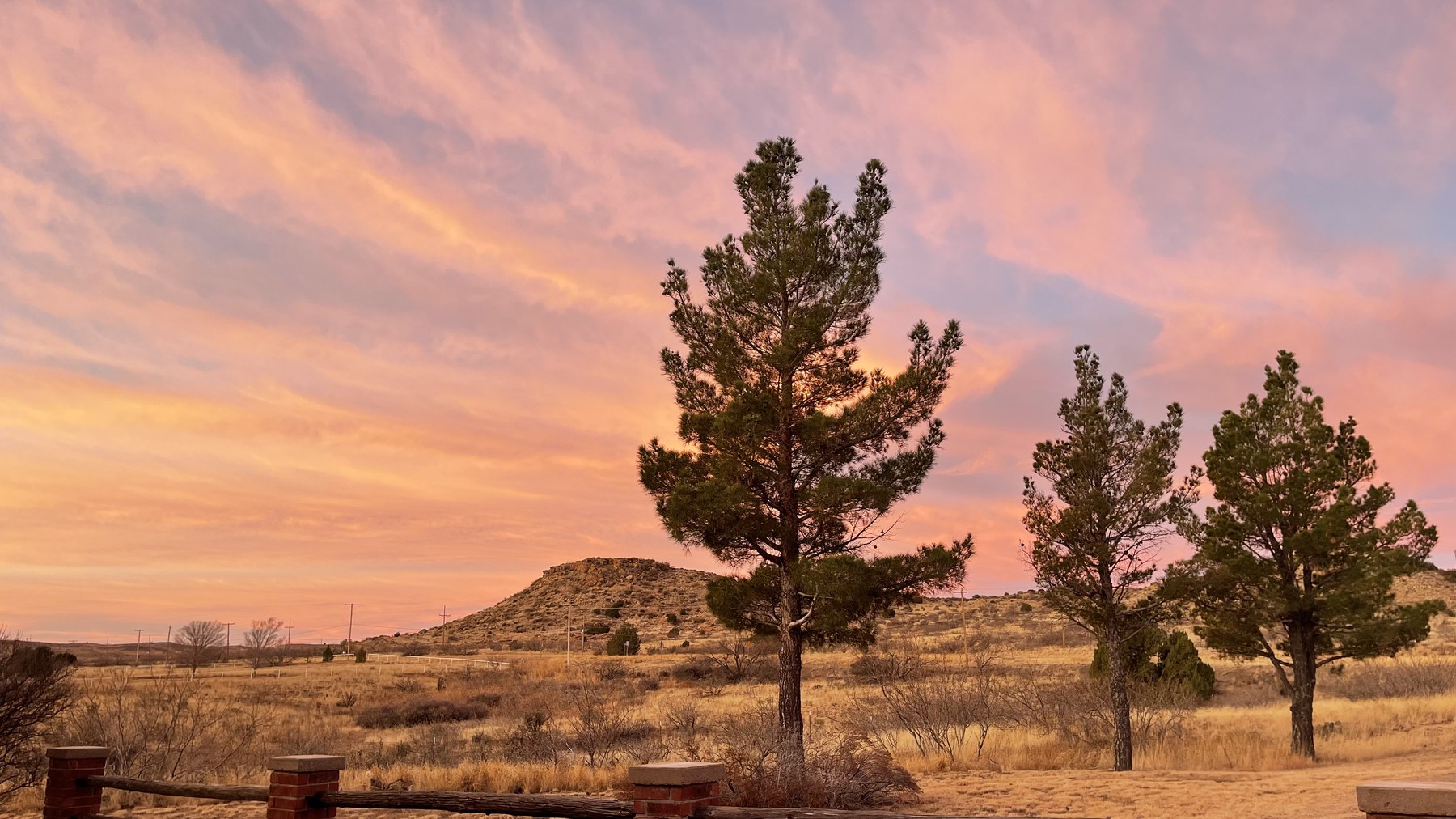 Sunset over Sunlit Ranch with mesa and moon
