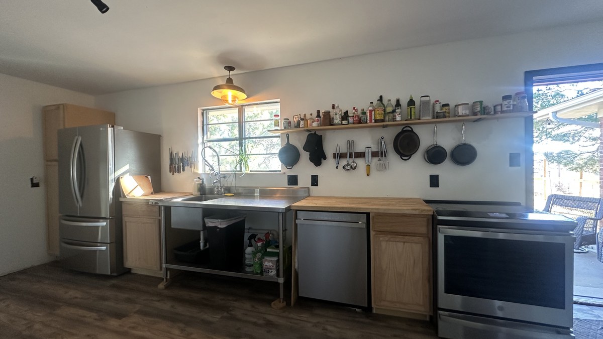 Kitchen with stainless appliances and open shelving