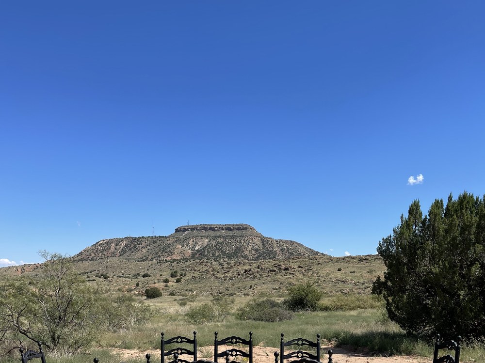 Outdoor dining table with mesa backdrop