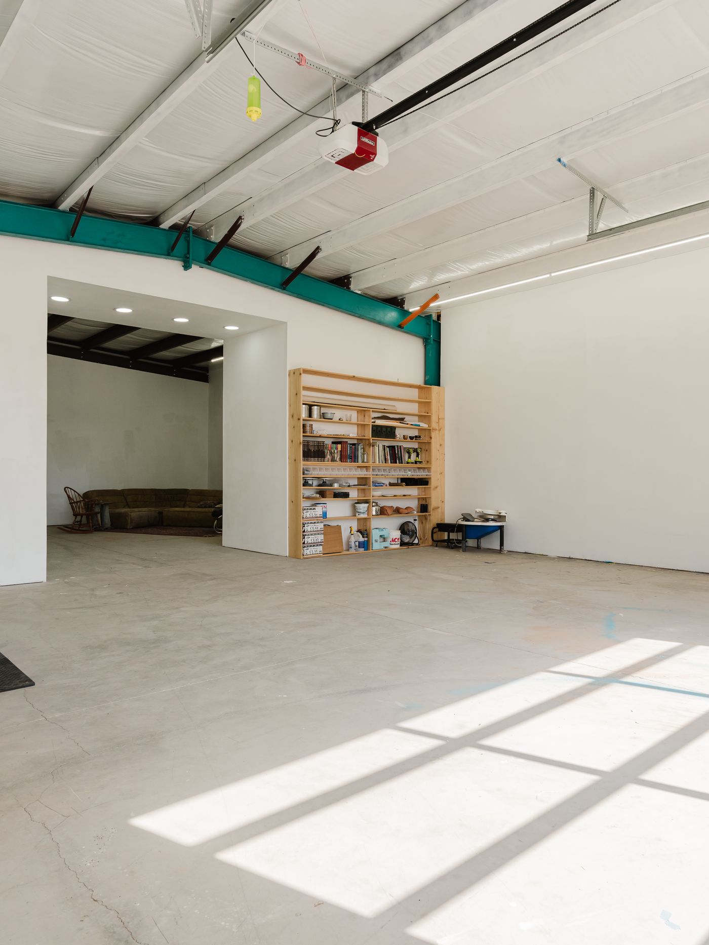 Inside the studio with light through the glass garage door